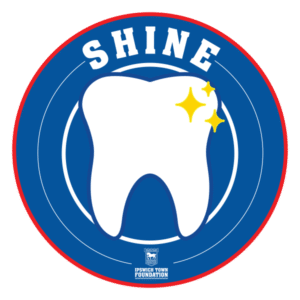 Logo for Ipswich Town Foundation's SHINE programme, showing a tooth on a blue background.